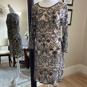 Size 8 nude with a slate colored design cocktail dress by Pissaro Nights NWT